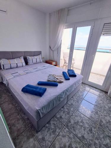 a bedroom with a large bed with blue pillows on it at Akimaria Residence in Oropesa del Mar