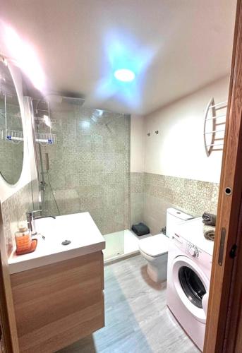 a bathroom with a sink and a washing machine at CasaGerman in Sierra Nevada