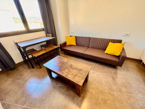 a living room with a couch and a table at Perita Apartamentos in Mataró