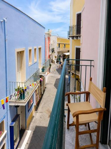 a balcony with a chair and a view of a street at Maridea - Il Balcone sulla Storia in Ponza