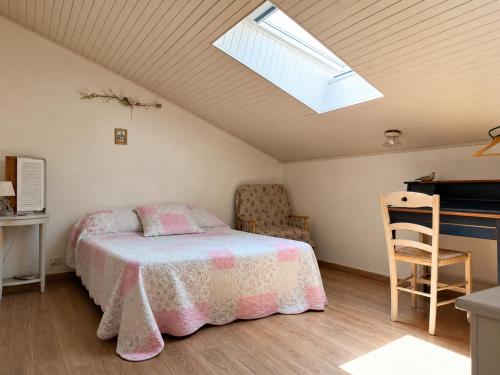 a bedroom with a bed and a skylight at Santon in Eugénie-les-Bains