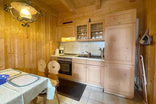a kitchen with wooden walls and a sink and a stove at Apartman Pepa in Bayerisch Eisenstein