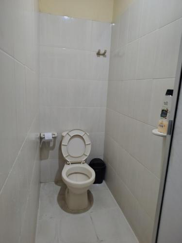a small bathroom with a toilet in a stall at EcoHonda Low Cost in Honda