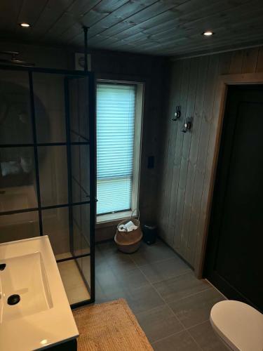 a bathroom with a shower and a sink and a toilet at Harevadet 217 in Volda