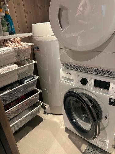 a washer and dryer in a kitchen next to a refrigerator at Harevadet 217 in Volda