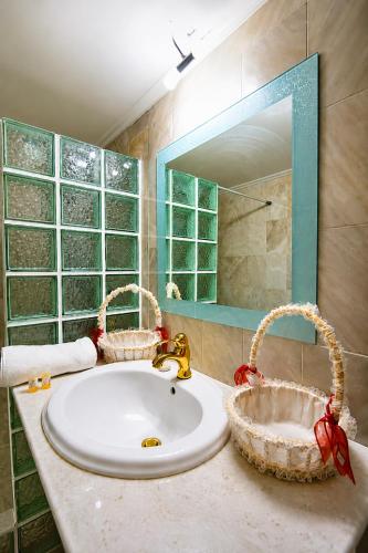 a bathroom with a sink and baskets on a counter at Aias Summer House in Aiándion