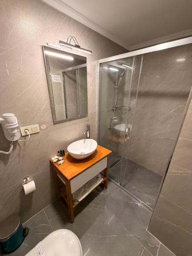 a bathroom with a sink and a shower at Rota Kadıköy in Istanbul