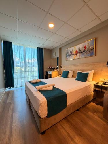 a hotel room with a large bed and a desk at Rota Kadıköy in Istanbul