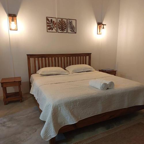 a bedroom with a bed with two towels on it at HillView in Port Mathurin