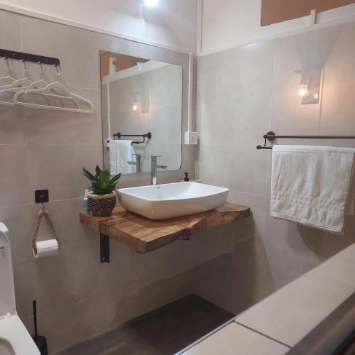 a bathroom with a white sink and a mirror at HillView in Port Mathurin