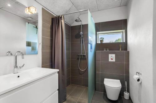 a bathroom with a shower and a toilet and a sink at FY180-Asperup-Daadyrvaenget-18 in Asperup