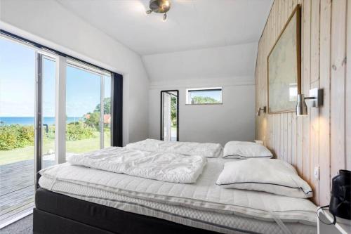 a bedroom with a large bed with a large window at FY180-Asperup-Daadyrvaenget-18 in Asperup