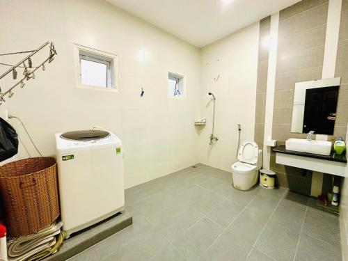 a bathroom with a sink and a toilet in it at Lala VILLA ĐÀ LẠT in Da Thien