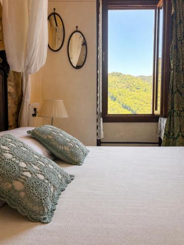 a bedroom with a bed and a window with a view at La Rocca Sospesa in Apricale