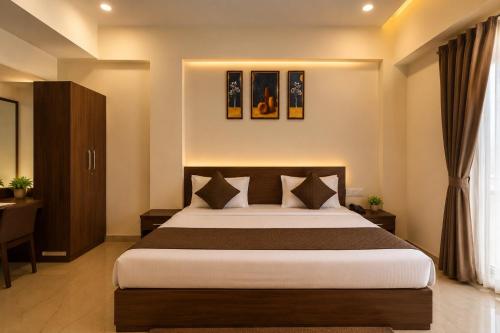 a bedroom with a large bed in a room at Hotel cressida green palace - near redisson squar in Indore