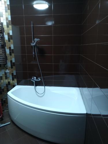 a bath tub in a bathroom with a shower at 19 Rustaveli Ave in Batumi