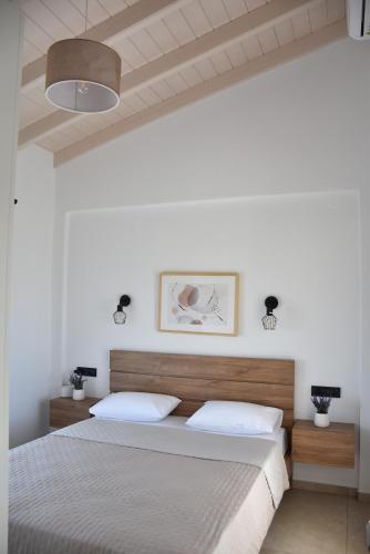 a bedroom with two beds with white walls at Saonia Apartment in Samothraki