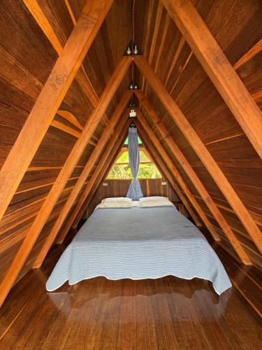 a bedroom with a bed in a wooden attic at Cabaña en Jericó in Jericó
