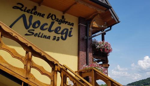 a sign on the side of a building at Zielone Wzgórza - Centrum Soliny - SPA 695-744-679 in Solina