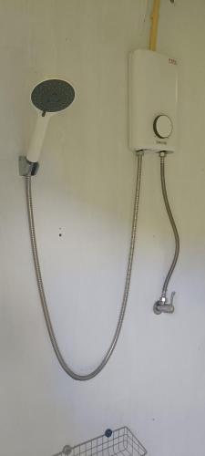 a shower with a hose attached to a wall at สะปันฮิลล์ Sapan Hill in Ban Huai Ti