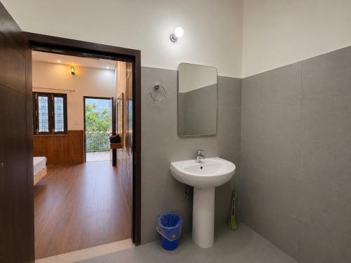 a bathroom with a sink and a mirror at Cross Hill House Mussoorie in Mussoorie