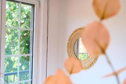 a mirror on a wall next to a window at Billion Stars Studio in Thymonia Beach