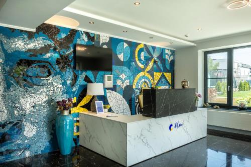 an office with a wall covered in colorful wallpaper at d'Eric Mamaia Nord in Mamaia Sat/Năvodari