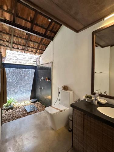 a bathroom with a toilet and a sink at Dunes Unawatuna Hotel in Unawatuna
