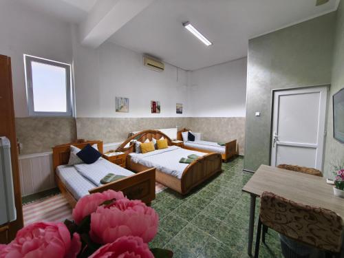 a hotel room with two beds and a table at Agape Speranta 96 in Piteşti