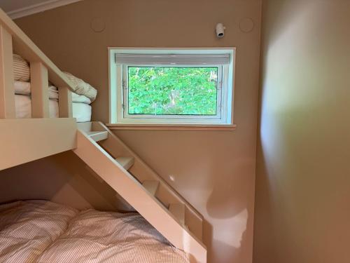 a small room with a bunk bed and a window at Stuga Marstrand in Marstrand