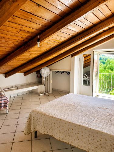 a bedroom with a large bed and a window at Appartamenti Villa Verde in Caprioli