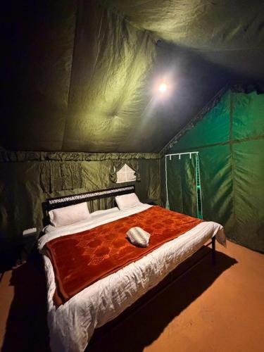 a bedroom with a bed in a tent at starry nights stay in Batakūt