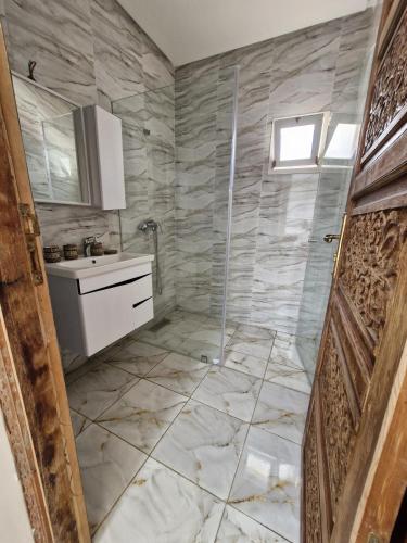 a bathroom with a shower and a sink at Riad Rabat Laalou in Rabat