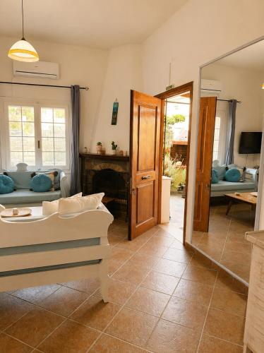 a living room with a couch and a mirror at Mamas House Spetses in Spetses