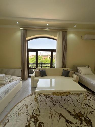 a bedroom with a large bed and a couch at Jahanshah GuestHouse in Samarkand