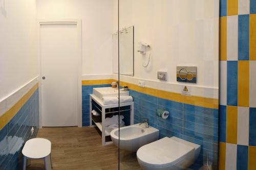 a bathroom with a toilet and a sink at Dea Guest House in Sorrento