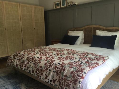 a bed with a red and white blanket on it at Stunning New Apartment Senningerberg in Niederanven