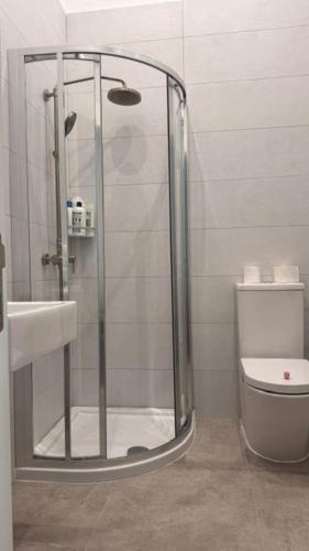 a shower in a bathroom with a toilet and a sink at Secret Villa - Room Lily in Taʼ Lampuka