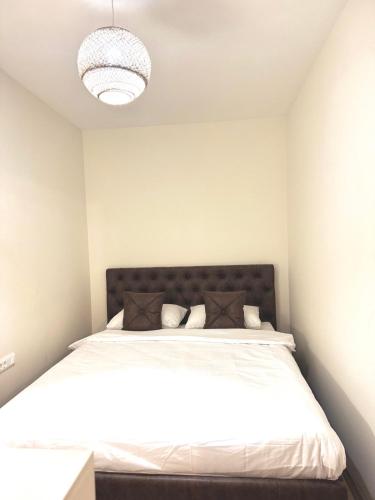a bedroom with a bed with white sheets and pillows at Sand and stone oasis in Ohrid