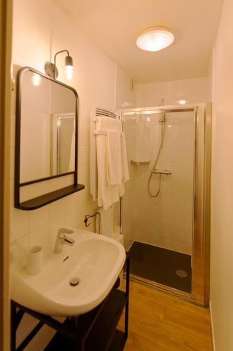 a bathroom with a sink and a shower at Auberge du Fel in Le Fel