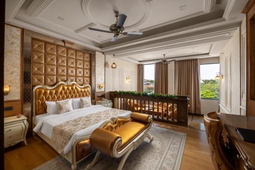a bedroom with a large bed and a desk at Blueworld Castles in Kānpur