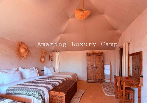 a bedroom with a large bed in a room at Amazing Luxury Camp in Merzouga