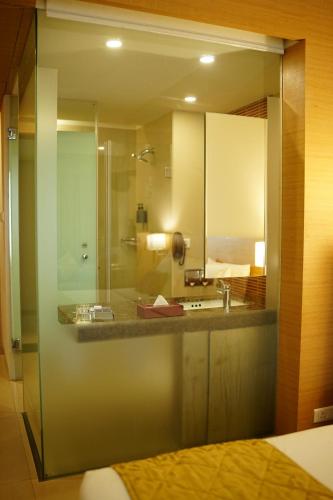 a bathroom with a sink and a mirror at Radha Regent Electronic City in Bangalore