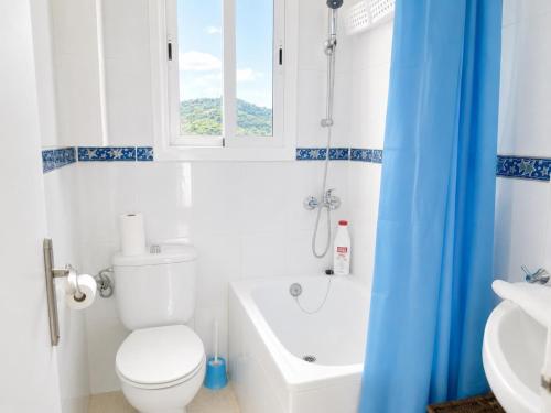 a bathroom with a toilet and a tub and a sink at Mediterranean Escape - Sea Views Pool in Malgrat de Mar