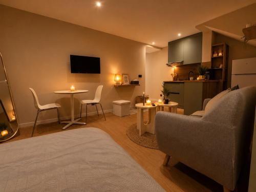 a living room with a couch and a table at Côte-et-vins Gîte Le Cocon in Chagny