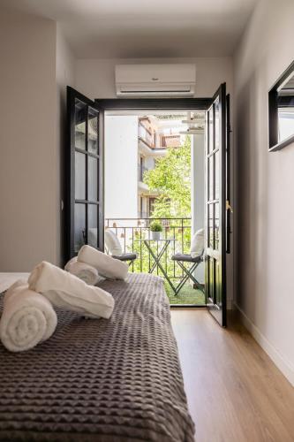 a bedroom with a large bed and a balcony at La Calma apartamento muy cerca del centro in Cazorla