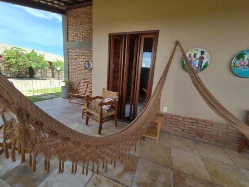 a hammock on the patio of a house at Casa Brisas 17 in Luis Correia
