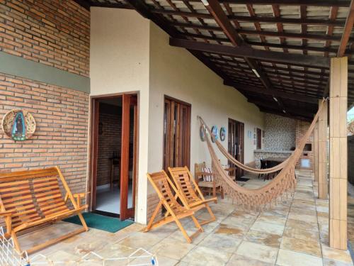 a patio with chairs and hammocks on a house at Casa Brisas 17 in Luis Correia
