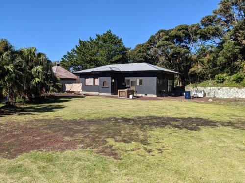 a house with a large yard in front of it at Big Island Base 一組限定の庭付き一棟貸し BBQ 焚き火 テントサウナ 最大6名 in Oshima