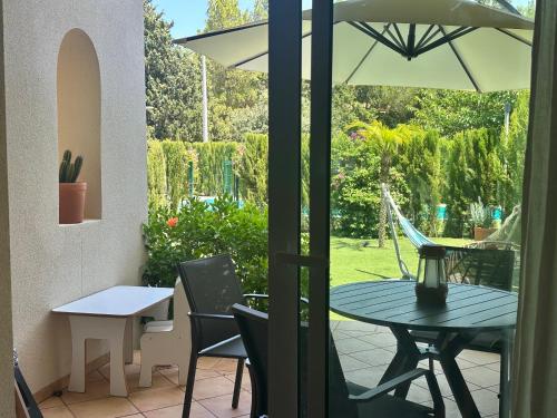 a patio with a table and chairs and an umbrella at Onda in Denia